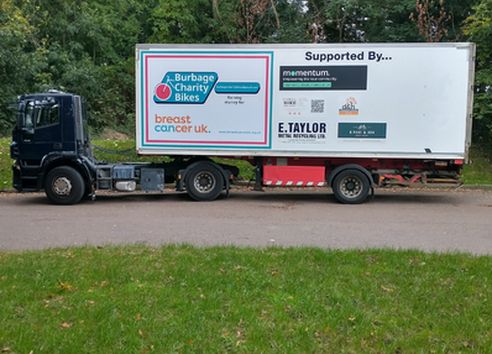 Burbage Bikes transport lorry displaying Breast Cancer UK logo