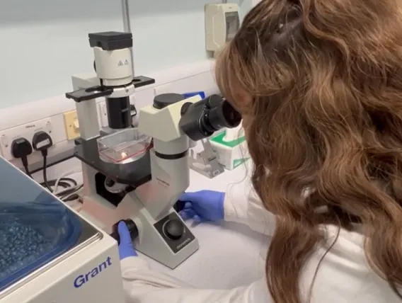 Woman looking into microscope